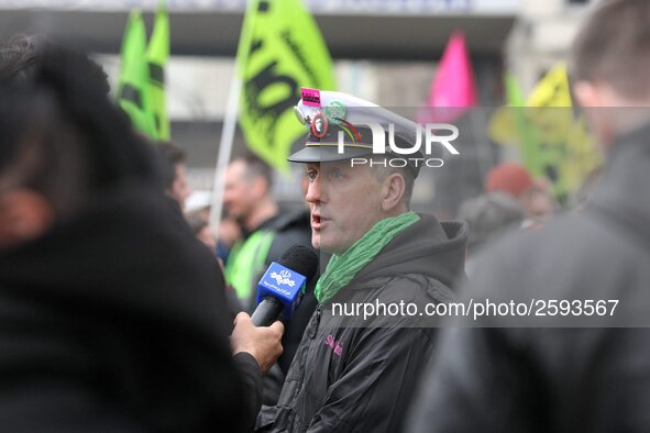 An employee of the French state owned railway company SNCF answers to the foreign press during a  demonstration in front of the Gare de l'Es...