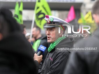 An employee of the French state owned railway company SNCF answers to the foreign press during a  demonstration in front of the Gare de l'Es...