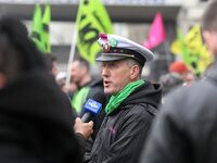 An employee of the French state owned railway company SNCF answers to the foreign press during a  demonstration in front of the Gare de l'Es...