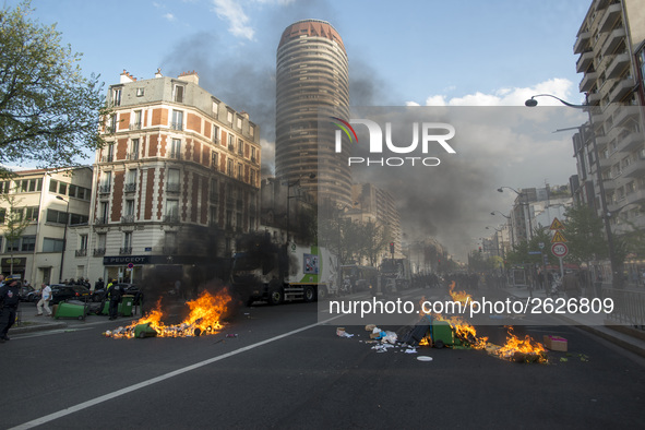 Police stand guard behind burning garbage bins as they face off with protesters near Paris Tolbiac university campus on April 20, 2018 in Pa...