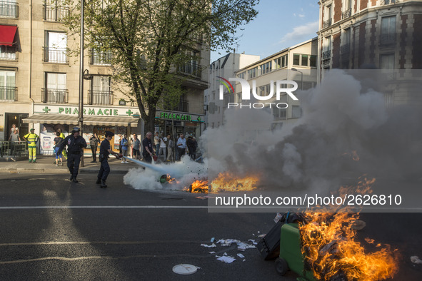 Police stand guard behind burning garbage bins as they face off with protesters near Paris Tolbiac university campus on April 20, 2018 in Pa...