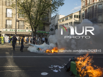 Police stand guard behind burning garbage bins as they face off with protesters near Paris Tolbiac university campus on April 20, 2018 in Pa...