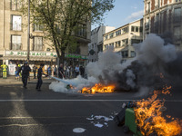 Police stand guard behind burning garbage bins as they face off with protesters near Paris Tolbiac university campus on April 20, 2018 in Pa...