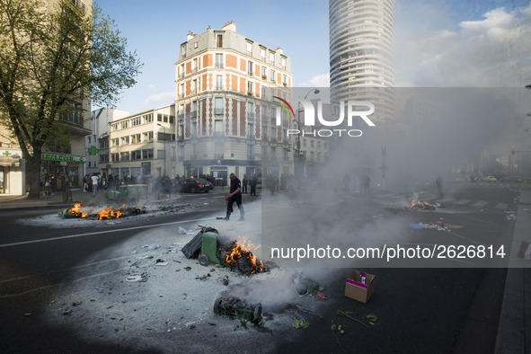 Police stand guard behind burning garbage bins as they face off with protesters near Paris Tolbiac university campus on April 20, 2018 in Pa...