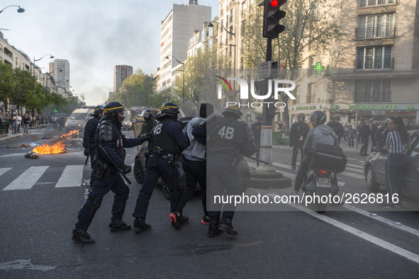 Police stand guard behind burning garbage bins as they face off with protesters near Paris Tolbiac university campus on April 20, 2018 in Pa...