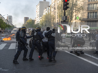 Police stand guard behind burning garbage bins as they face off with protesters near Paris Tolbiac university campus on April 20, 2018 in Pa...