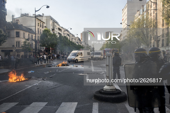 Police stand guard behind burning garbage bins as they face off with protesters near Paris Tolbiac university campus on April 20, 2018 in Pa...