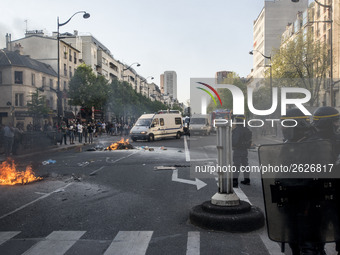 Police stand guard behind burning garbage bins as they face off with protesters near Paris Tolbiac university campus on April 20, 2018 in Pa...