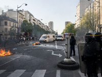 Police stand guard behind burning garbage bins as they face off with protesters near Paris Tolbiac university campus on April 20, 2018 in Pa...