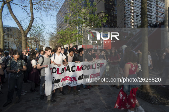 Students hold a banner reading "Tolbiac mobilized same Macron, same fight!" as they gather in front of the Paris Tolbiac university campus o...