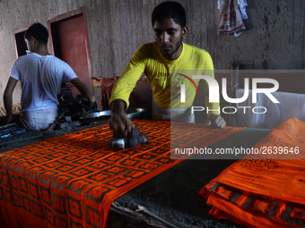 Bangladeshi labors working in the Batik Cloth industry at Narsingdi area near Dhaka, Bangladesh, on April 26, 2018. Each Worker earns par da...