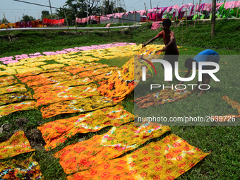 Bangladeshi labors working in the Batik Cloth industry at Narsingdi area near Dhaka, Bangladesh, on April 26, 2018. Each Worker earns par da...