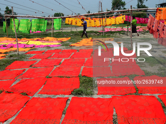 Bangladeshi labors working in the Batik Cloth industry at Narsingdi area near Dhaka, Bangladesh, on April 26, 2018. Each Worker earns par da...