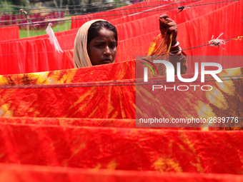 Bangladeshi labors working in the Batik Cloth industry at Narsingdi area near Dhaka, Bangladesh, on April 26, 2018. Each Worker earns par da...