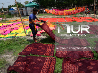 Bangladeshi labors working in the Batik Cloth industry at Narsingdi area near Dhaka, Bangladesh, on April 26, 2018. Each Worker earns par da...