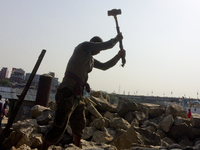  A stone breaking worker is working in a field in a heated mid-summer day on April 27th 2018, in Dhaka, Bangladesh. (