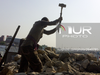  A stone breaking worker is working in a field in a heated mid-summer day on April 27th 2018, in Dhaka, Bangladesh. (