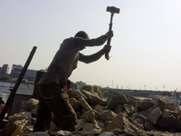  A stone breaking worker is working in a field in a heated mid-summer day on April 27th 2018, in Dhaka, Bangladesh. (