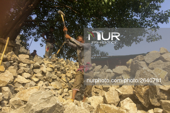  A stone breaking worker is working in a field in a heated mid-summer day on April 27th 2018, in Dhaka, Bangladesh. 