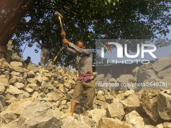  A stone breaking worker is working in a field in a heated mid-summer day on April 27th 2018, in Dhaka, Bangladesh. (