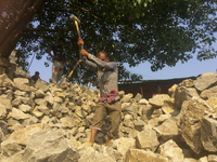  A stone breaking worker is working in a field in a heated mid-summer day on April 27th 2018, in Dhaka, Bangladesh. (