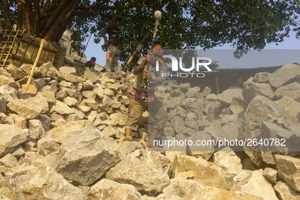  A stone breaking worker is working in a field in a heated mid-summer day on April 27th 2018, in Dhaka, Bangladesh. 