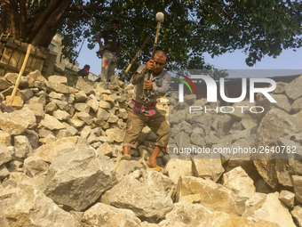  A stone breaking worker is working in a field in a heated mid-summer day on April 27th 2018, in Dhaka, Bangladesh. (