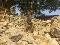  A stone breaking worker is working in a field in a heated mid-summer day on April 27th 2018, in Dhaka, Bangladesh. (