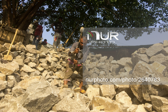  A stone breaking worker is working in a field in a heated mid-summer day on April 27th 2018, in Dhaka, Bangladesh. 