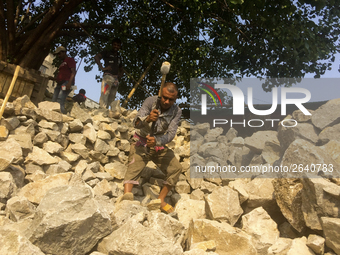  A stone breaking worker is working in a field in a heated mid-summer day on April 27th 2018, in Dhaka, Bangladesh. (