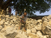  A stone breaking worker is working in a field in a heated mid-summer day on April 27th 2018, in Dhaka, Bangladesh. (