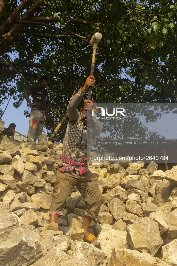  A stone breaking worker is working in a field in a heated mid-summer day on April 27th 2018, in Dhaka, Bangladesh. 