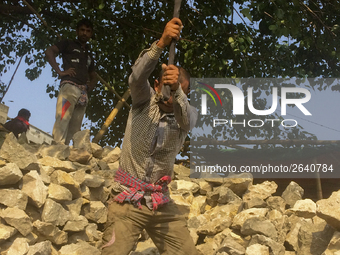  A stone breaking worker is working in a field in a heated mid-summer day on April 27th 2018, in Dhaka, Bangladesh. (