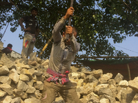  A stone breaking worker is working in a field in a heated mid-summer day on April 27th 2018, in Dhaka, Bangladesh. (