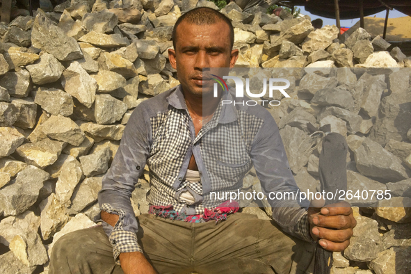  A stone breaking worker is working in a field in a heated mid-summer day on April 27th 2018, in Dhaka, Bangladesh. 