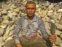  A stone breaking worker is working in a field in a heated mid-summer day on April 27th 2018, in Dhaka, Bangladesh. (