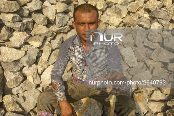  A stone breaking worker is working in a field in a heated mid-summer day on April 27th 2018, in Dhaka, Bangladesh. 