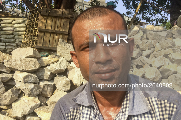  A stone breaking worker is working in a field in a heated mid-summer day on April 27th 2018, in Dhaka, Bangladesh. 