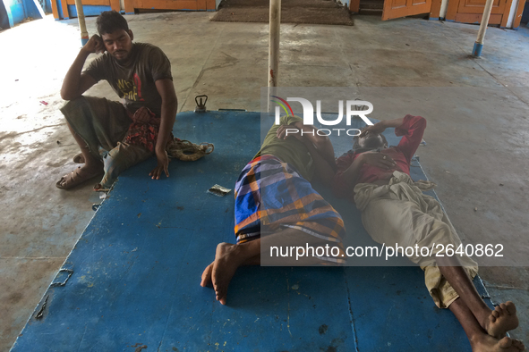 Port workers are taking rest in a ferry near by to their work station to ease themselves from extreme mid-noon summer heat on April 27th 201...