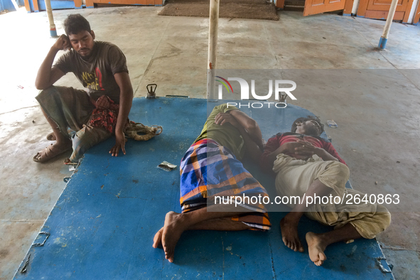 Port workers are taking rest in a ferry near by to their work station to ease themselves from extreme mid-noon summer heat on April 27th 201...