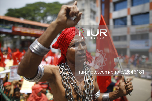 A Bangladeshi worker wears metal chain as he attends a May Day protest rally in Dhaka, Bangladesh on May 01, 2018. Thousands of workers of s...