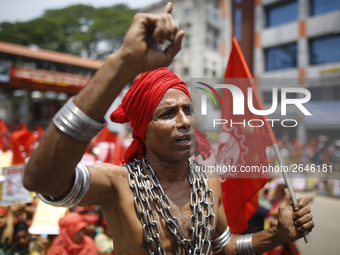 A Bangladeshi worker wears metal chain as he attends a May Day protest rally in Dhaka, Bangladesh on May 01, 2018. Thousands of workers of s...