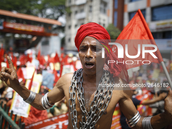 A Bangladeshi worker wears metal chain as he attends a May Day protest rally in Dhaka, Bangladesh on May 01, 2018. Thousands of workers of s...