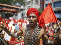 A Bangladeshi worker wears metal chain as he attends a May Day protest rally in Dhaka, Bangladesh on May 01, 2018. Thousands of workers of s...