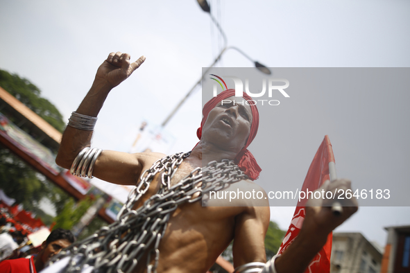 A Bangladeshi worker wears metal chain as he attends a May Day protest rally in Dhaka, Bangladesh on May 01, 2018. Thousands of workers of s...