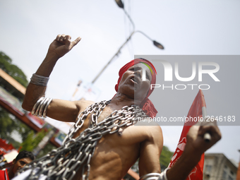 A Bangladeshi worker wears metal chain as he attends a May Day protest rally in Dhaka, Bangladesh on May 01, 2018. Thousands of workers of s...