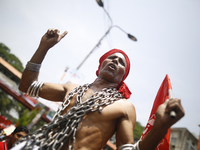 A Bangladeshi worker wears metal chain as he attends a May Day protest rally in Dhaka, Bangladesh on May 01, 2018. Thousands of workers of s...