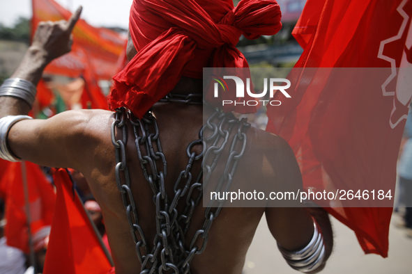 A Bangladeshi worker wears metal chain as he attends a May Day protest rally in Dhaka, Bangladesh on May 01, 2018. Thousands of workers of s...