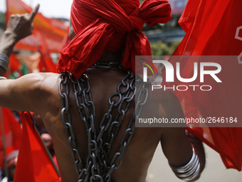 A Bangladeshi worker wears metal chain as he attends a May Day protest rally in Dhaka, Bangladesh on May 01, 2018. Thousands of workers of s...