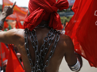 A Bangladeshi worker wears metal chain as he attends a May Day protest rally in Dhaka, Bangladesh on May 01, 2018. Thousands of workers of s...